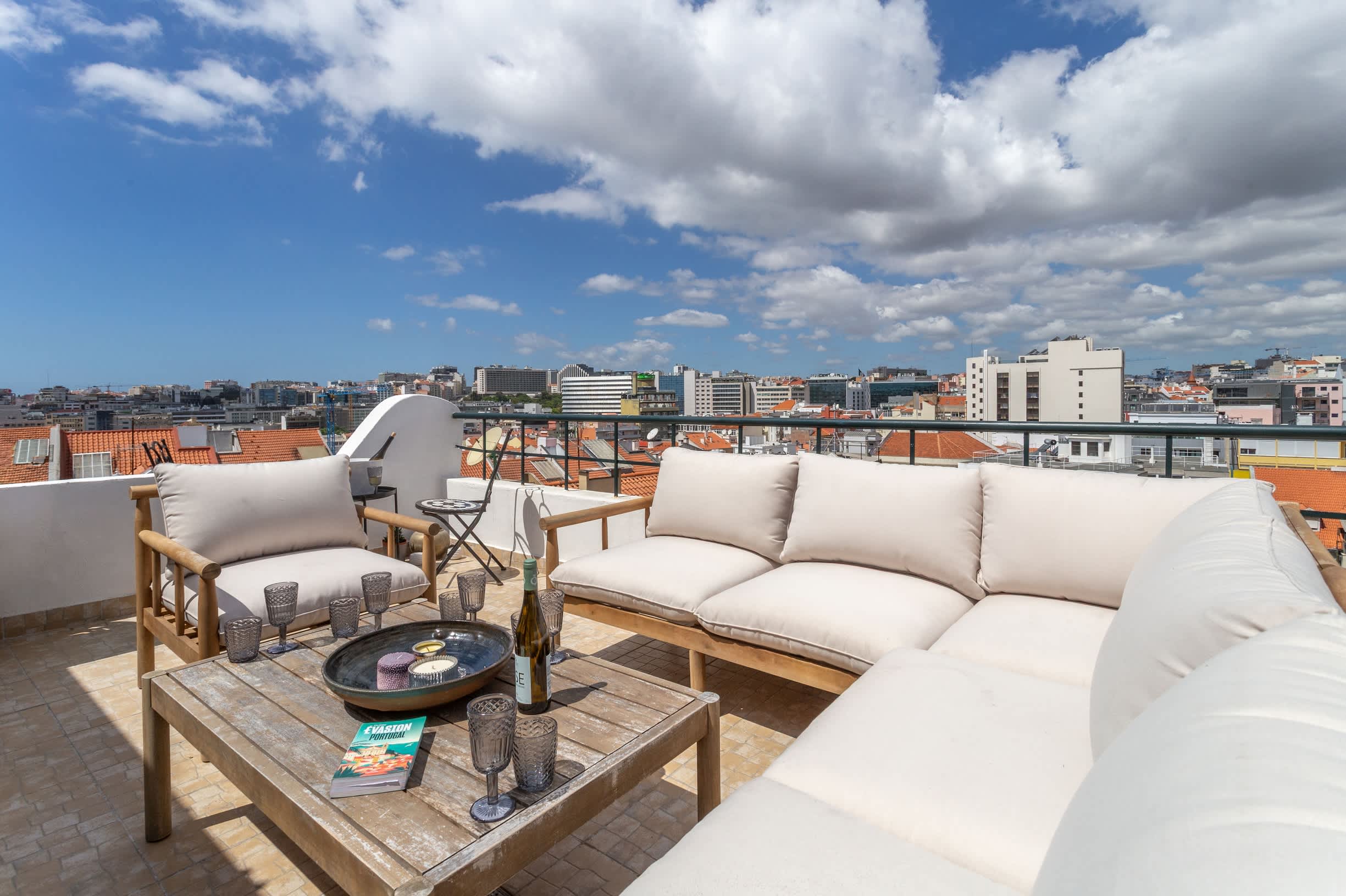 Rooftop terrace with outdoor sofas and views over Lisbon at an apartment in Saldanha managed by LD Ninja Stays